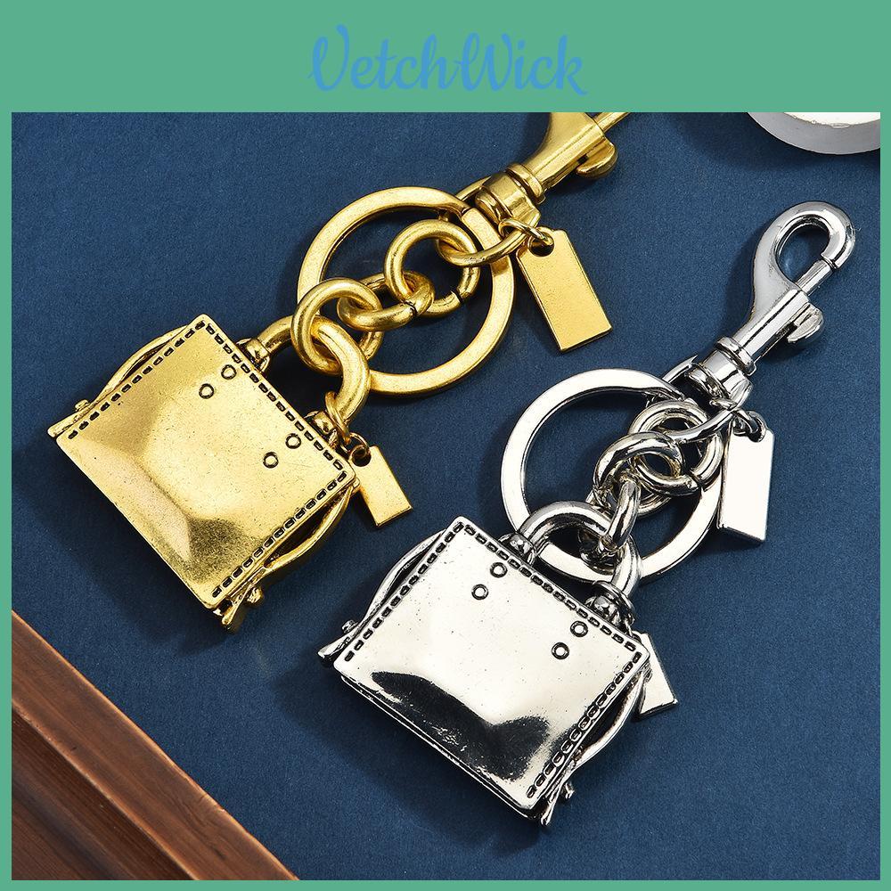 Metallic Keychain Bag Charm With Engraved Book Pattern For Fashion Accessories