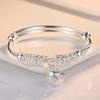 Bracelet ajustable argenté à clochettes creuses, bijou tendance pour femme, idéal pour les fêtes, les mariages et autres occasions spéciales.