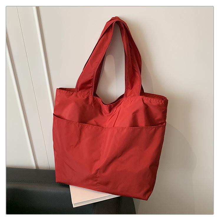 European-American Fashion Large Capacity Travel Bag - Solid Color, Nylon, Handheld or Shoulder Style for Women
