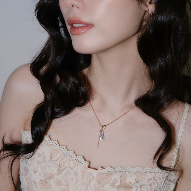 reve lock & cross two-tone drop necklace