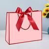 In-Stock White Cardboard Gift Bags with Bow Handle, Customizable Logo for Clothing Stores