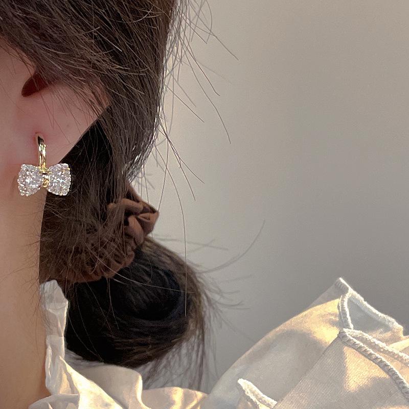 Korean version of light luxury bow zircon earrings women's niche unique design high-end sense super fairy versatile temperament stud earrings